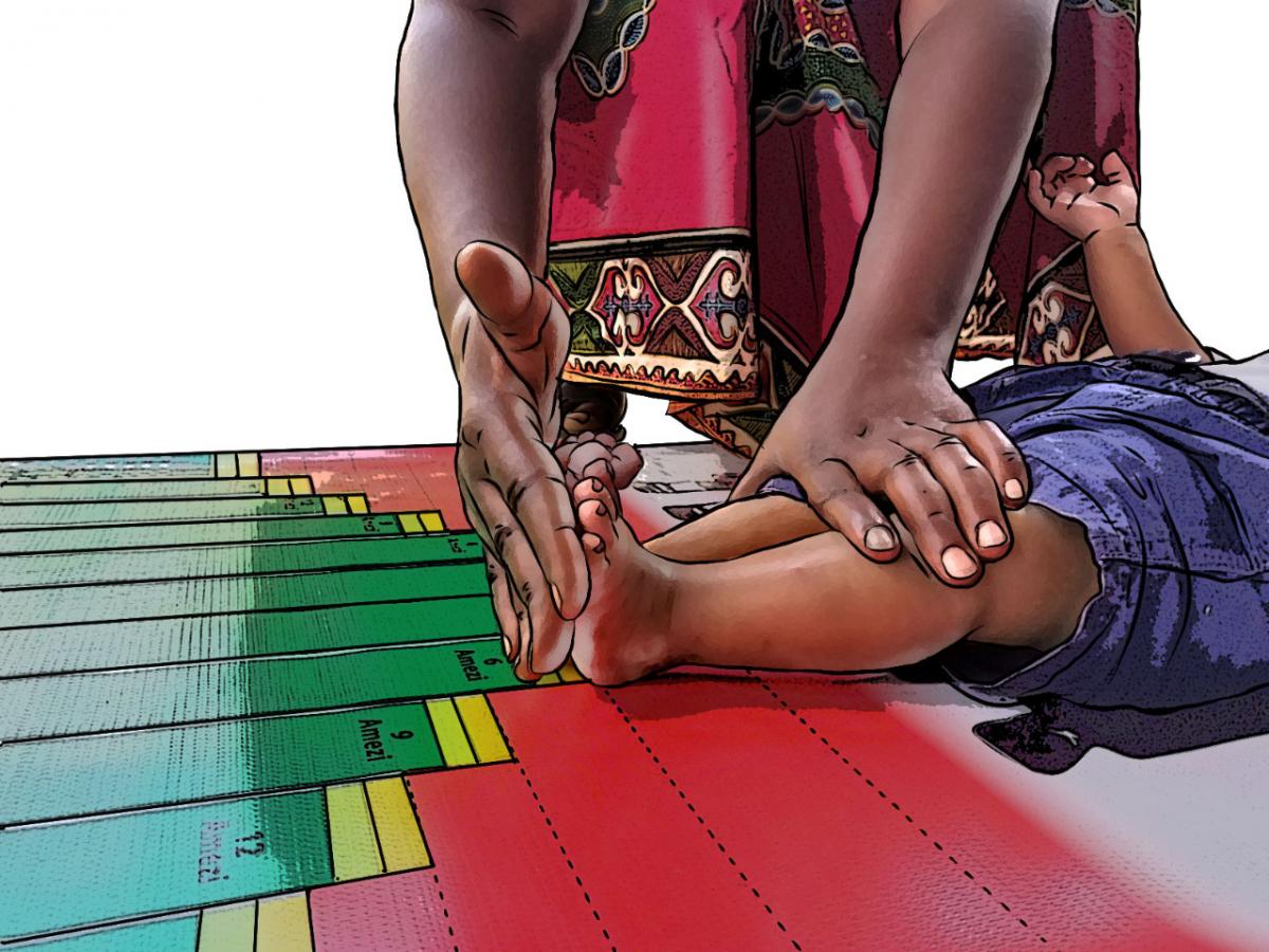 Child Health Care - Close up of community health worker measuring length at baby's feet - 03 - Rwanda